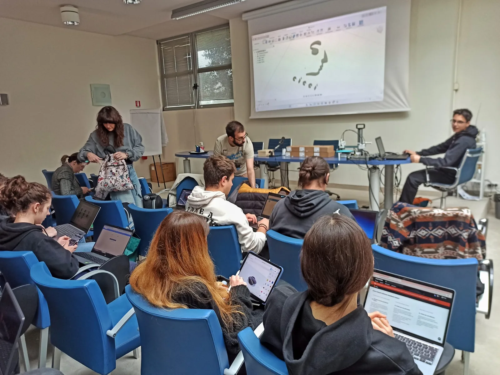 Classroom training session with CAD and product configuration projected on screen