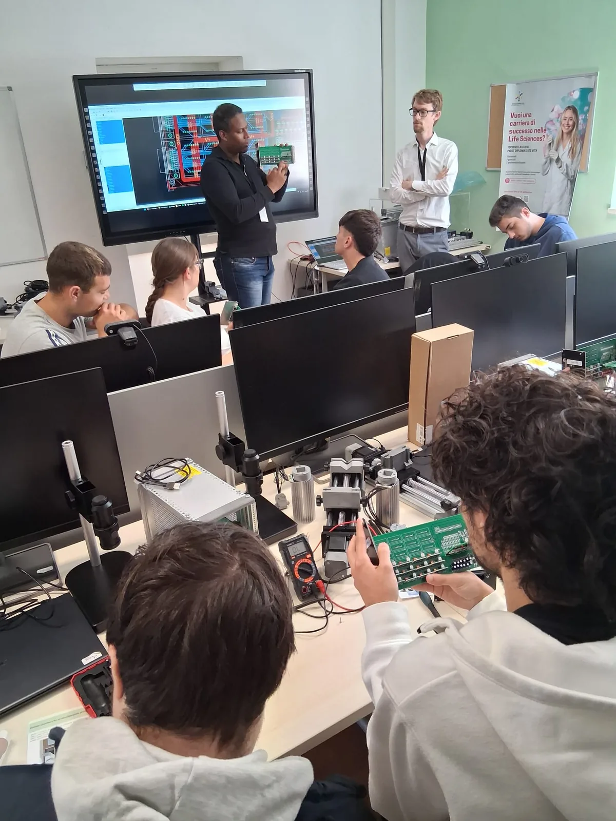 Students working on an electronics board during a Cicci Research product training session